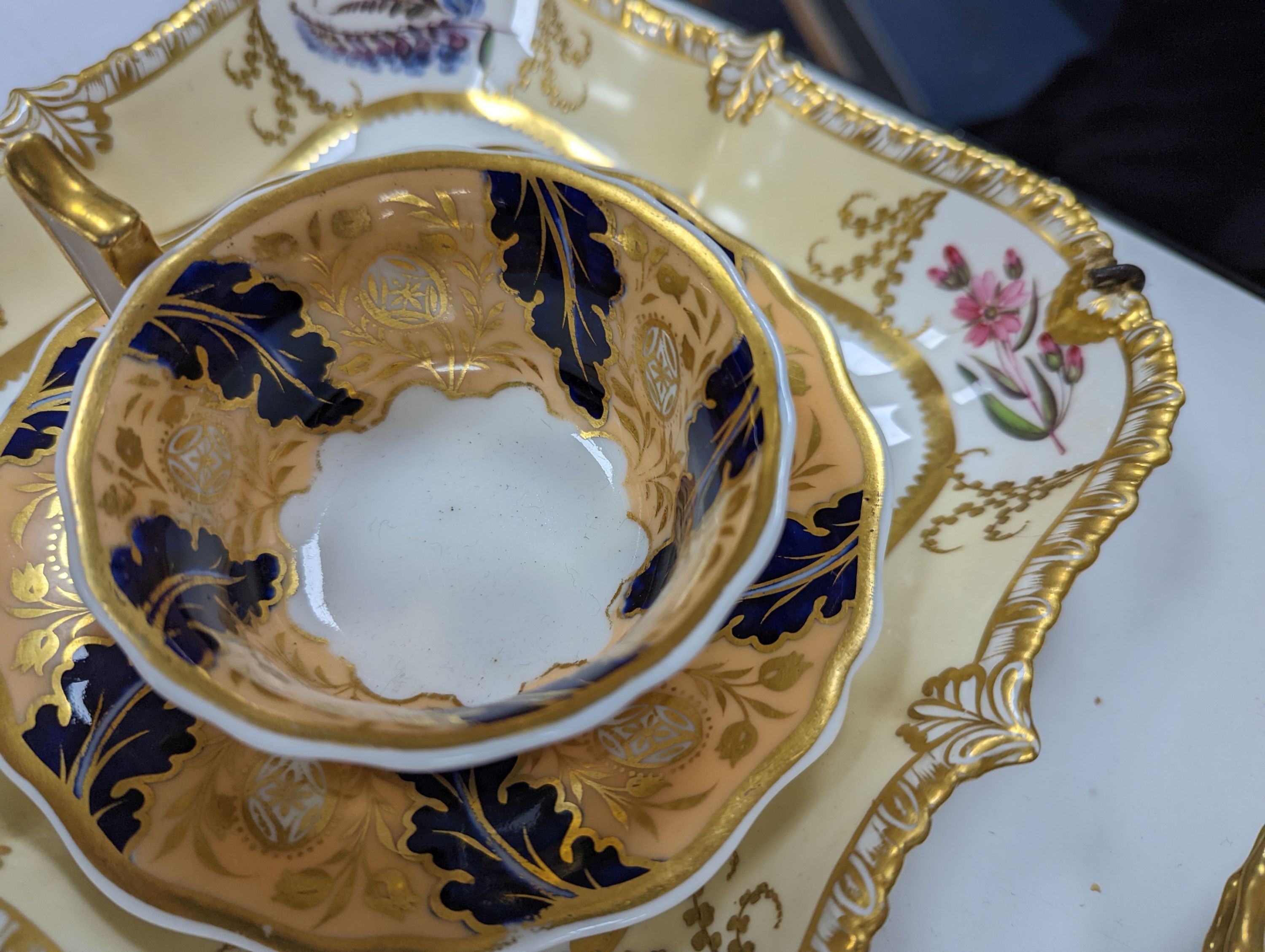 A small collection of Victorian porcelain tea cups and saucers and sundry dessert plates